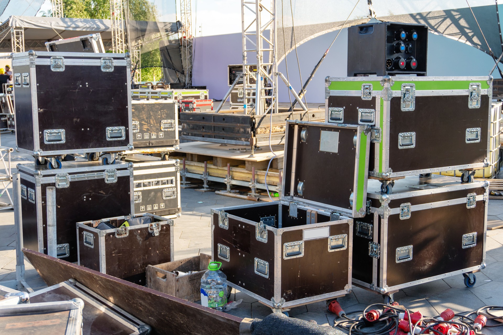 Preparation for concert outdoors. Cases for musical equipment near scene.