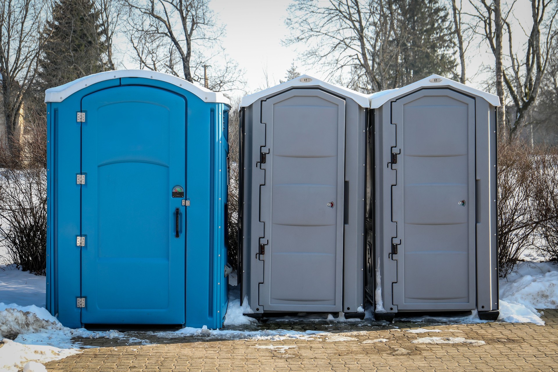Portable Toilets in a Snowy Outdoor Setting During Winter