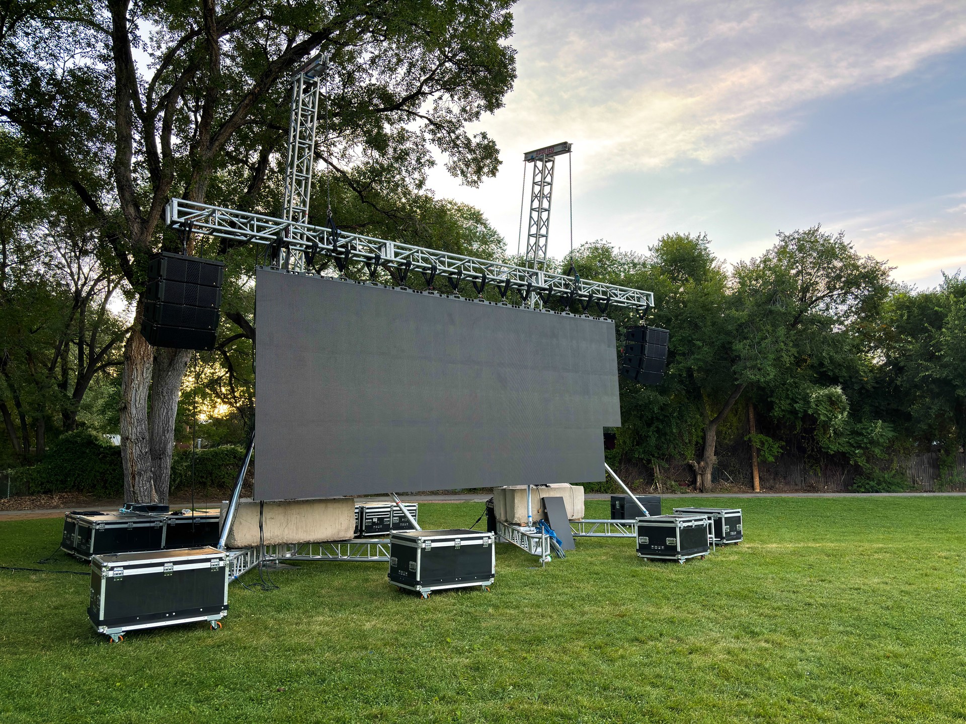 Large Outdoor TV Screen and Speakers on Park Lawn